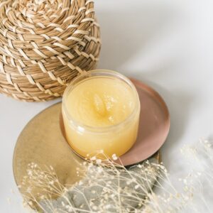 A candle sitting on top of a plate next to a basket.