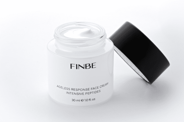A jar of face cream with a black lid.