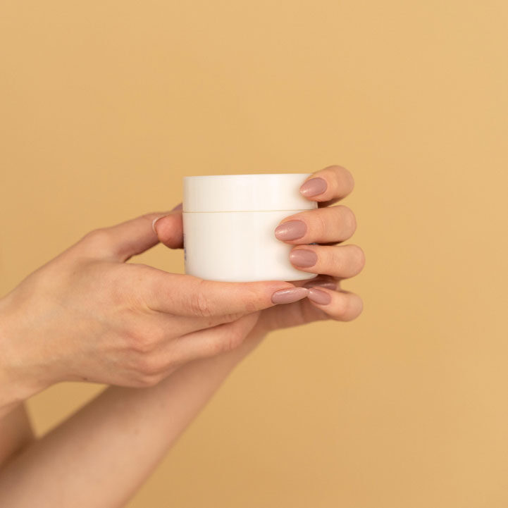 A person holding a cup of coffee in their hands.